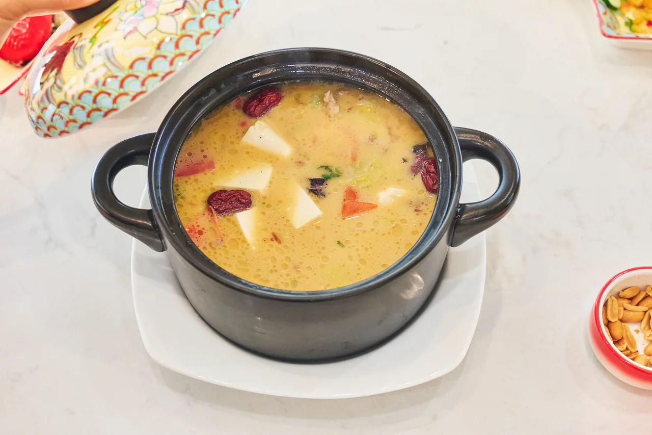 Hearty soup in a black claypot