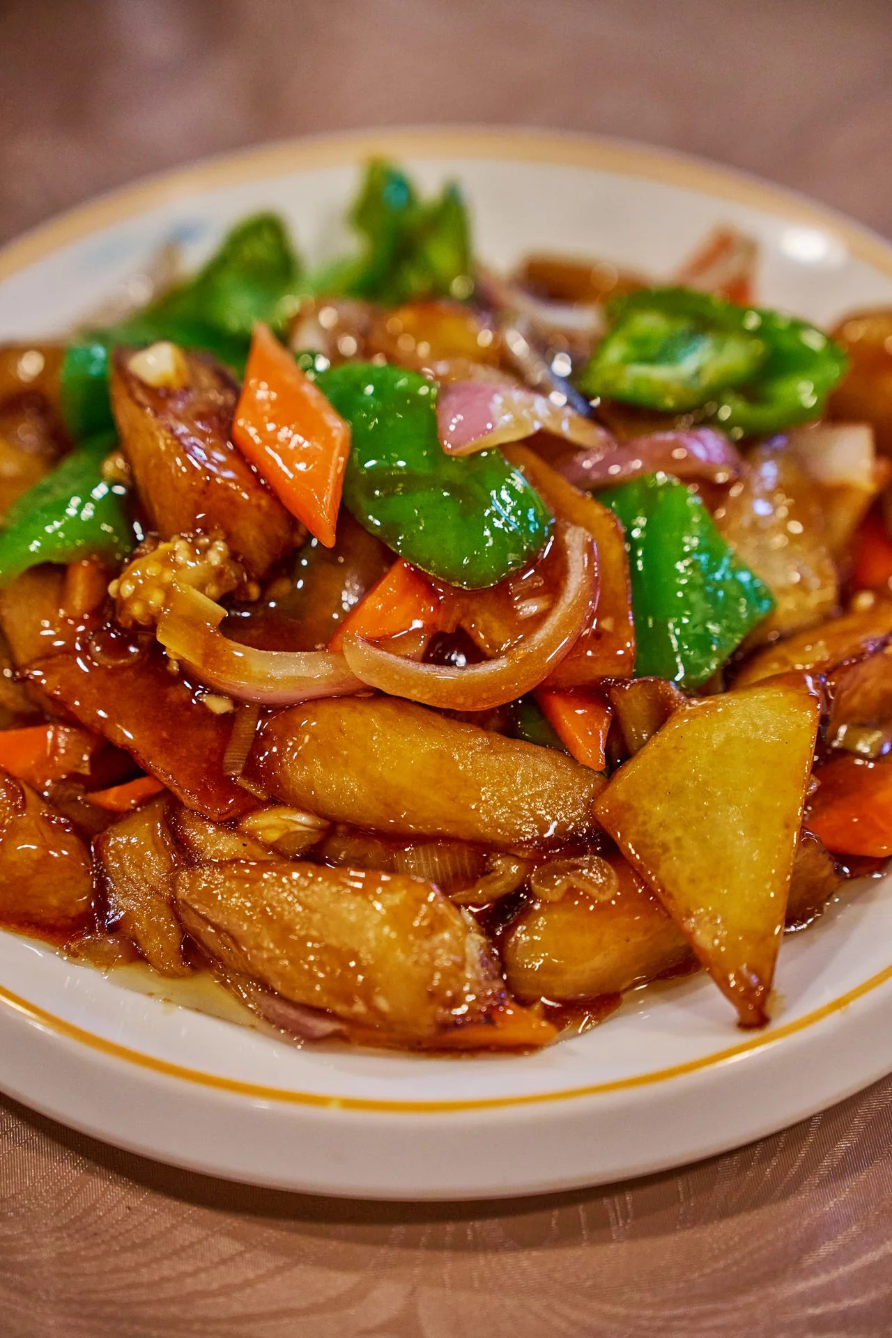 Sweet and sour stir-fry with green peppers, onion and carrot