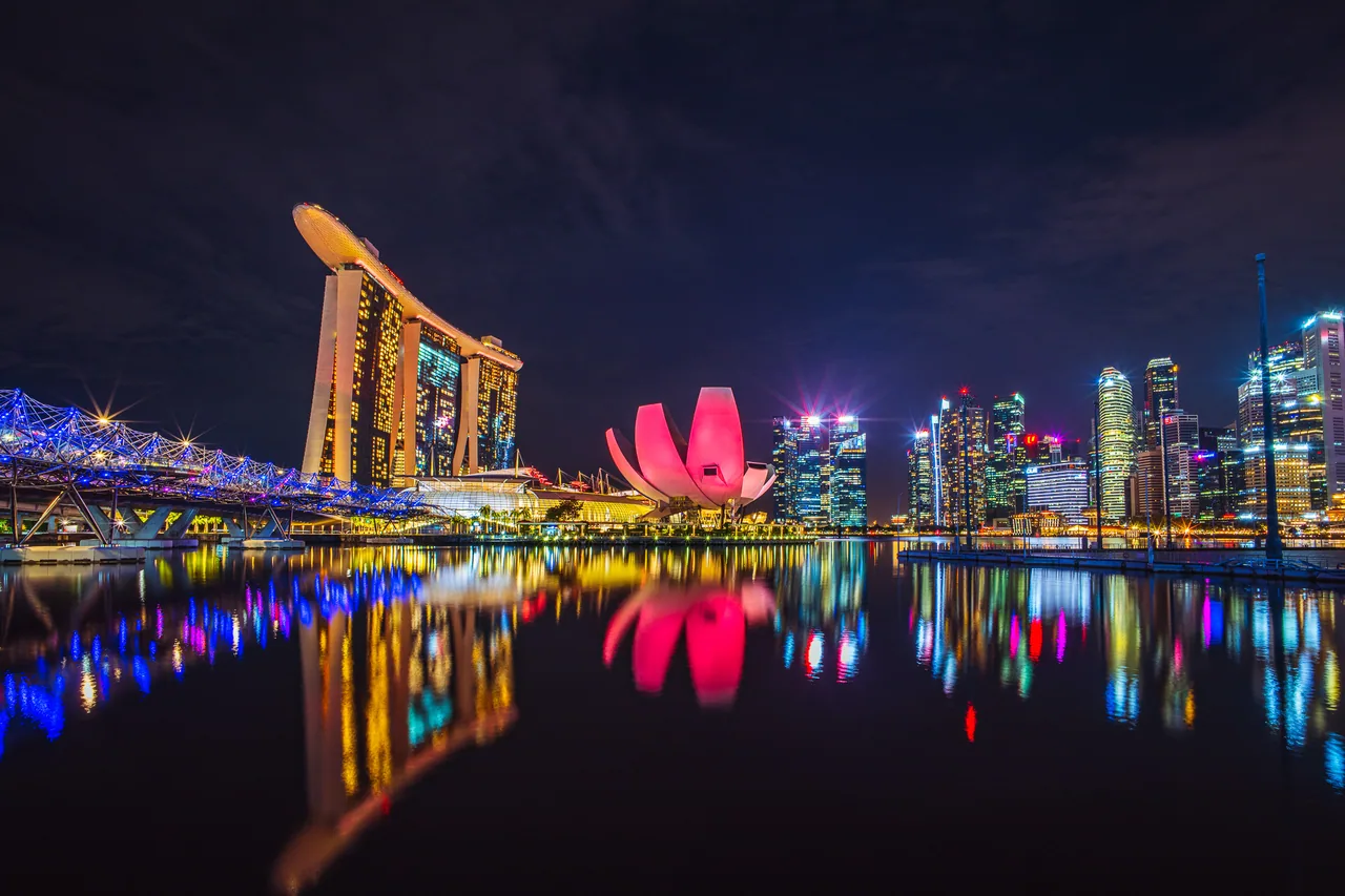 Marina Bay Sands and the ArtScience Museum reflected in Marina Bay at night