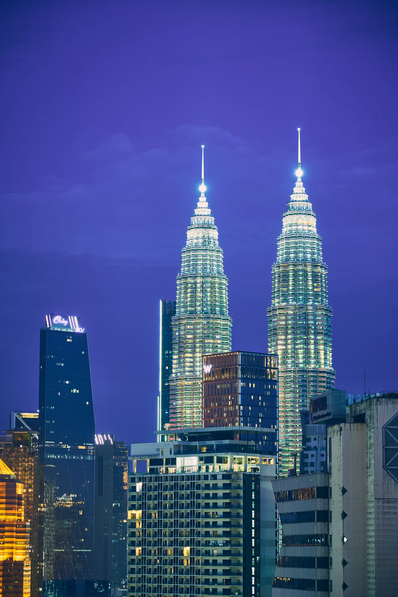 Petronas Twin Towers in Kuala Lumpur lit up at blue hour