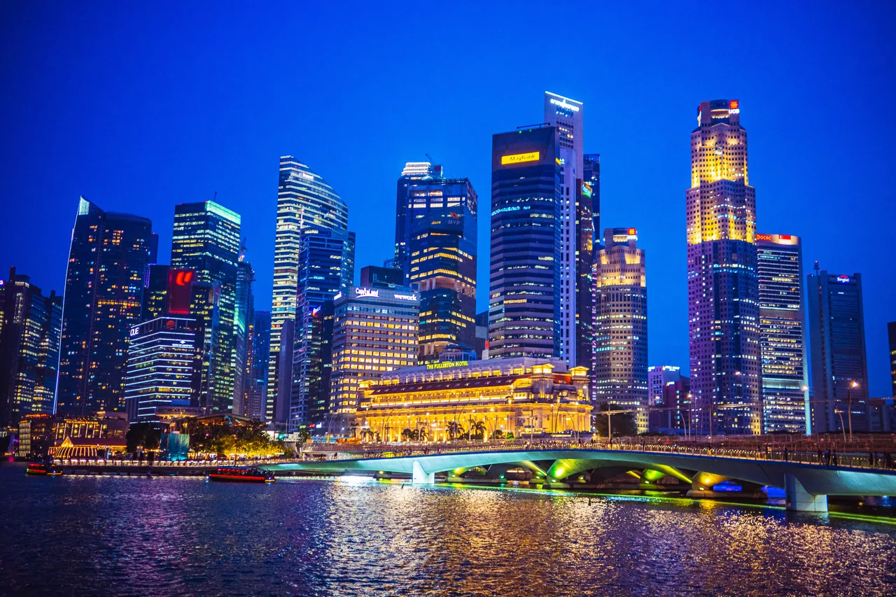 Singapore city skyline reflected in the river at blue hour