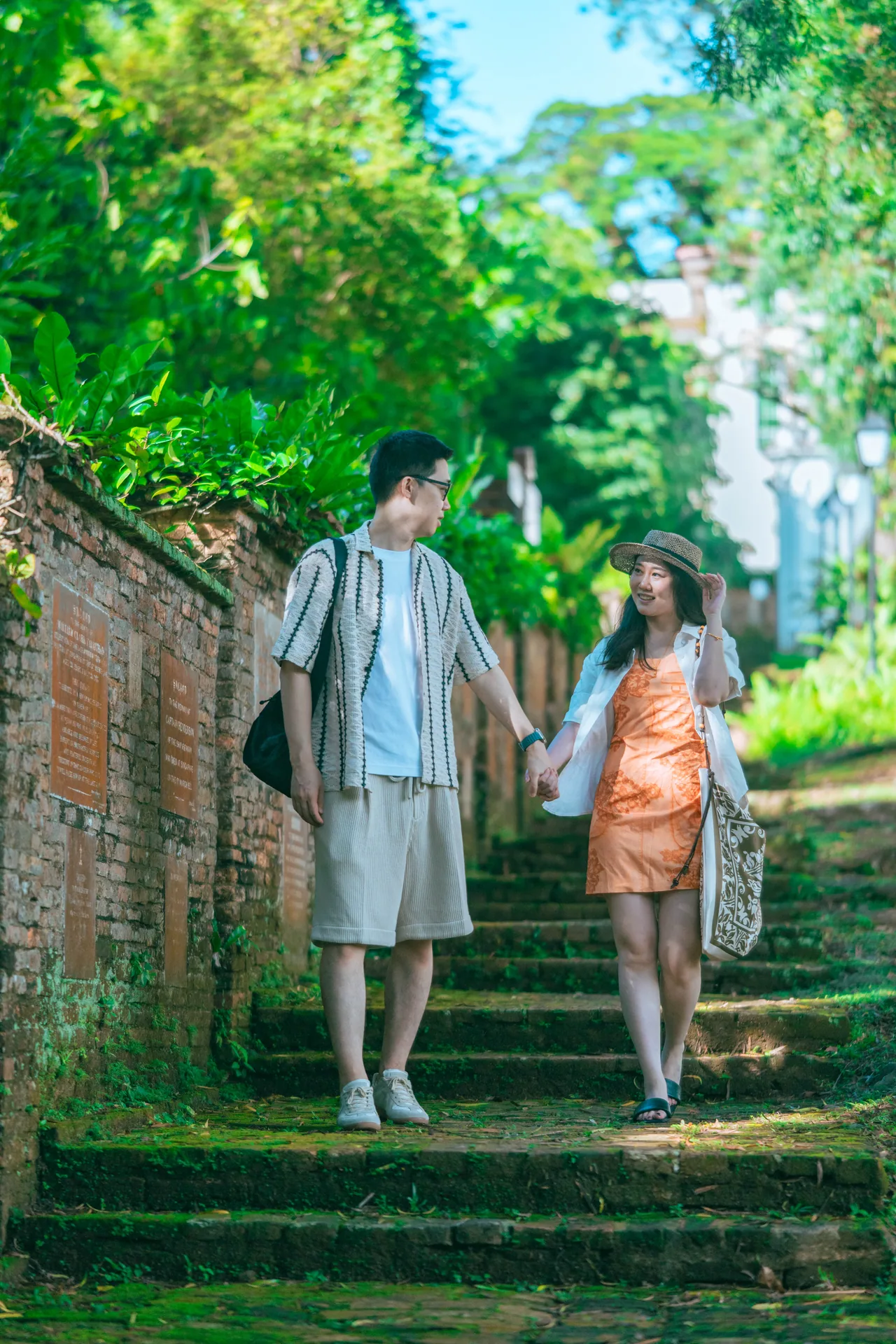 Couple walking hand in hand down garden steps