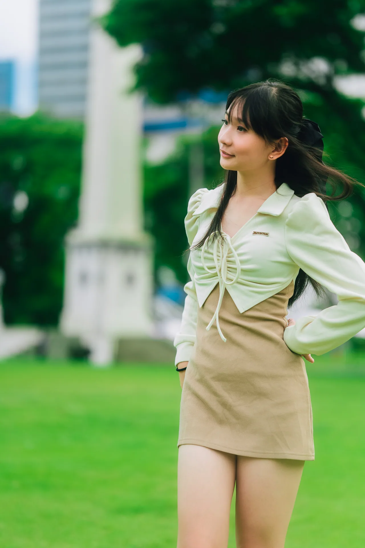 Woman on a green lawn in a light jacket