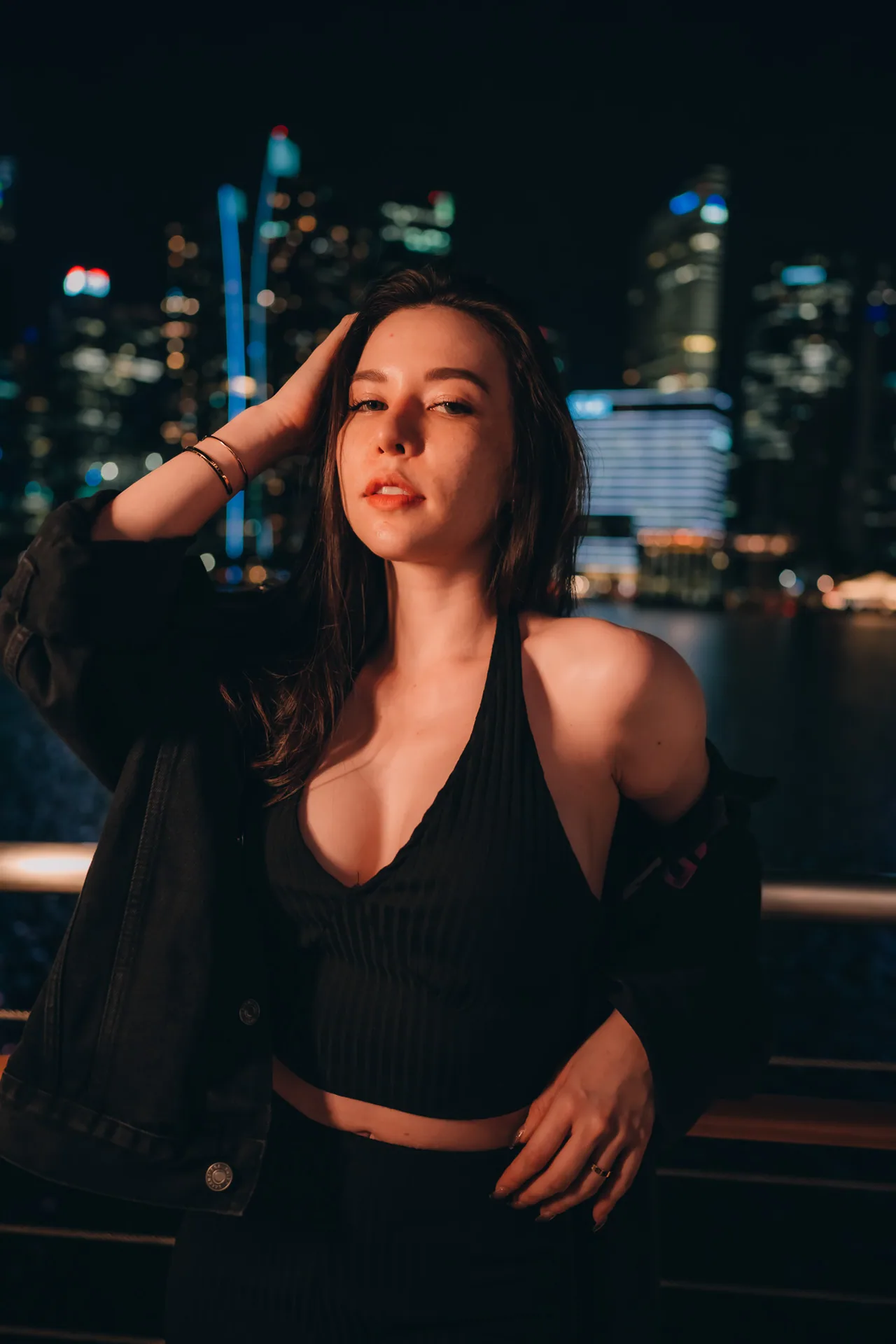 Moody night portrait with the city skyline behind